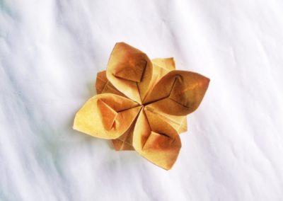 brown paper flower on white textile