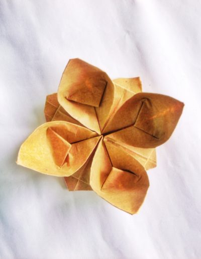 brown paper flower on white textile